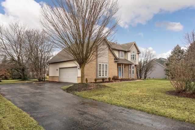 traditional-style home with a garage, brick siding, a front lawn, and aphalt driveway