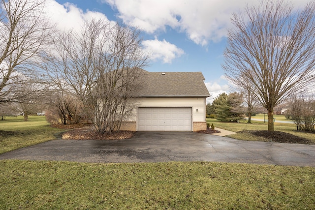 view of home's exterior featuring an attached garage, brick siding, driveway, a lawn, and roof with shingles