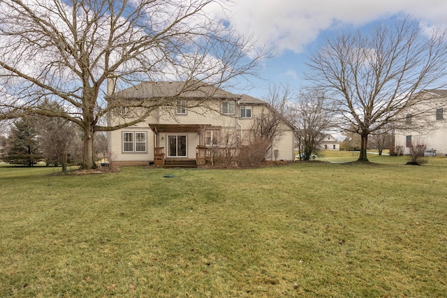 back of house featuring a lawn