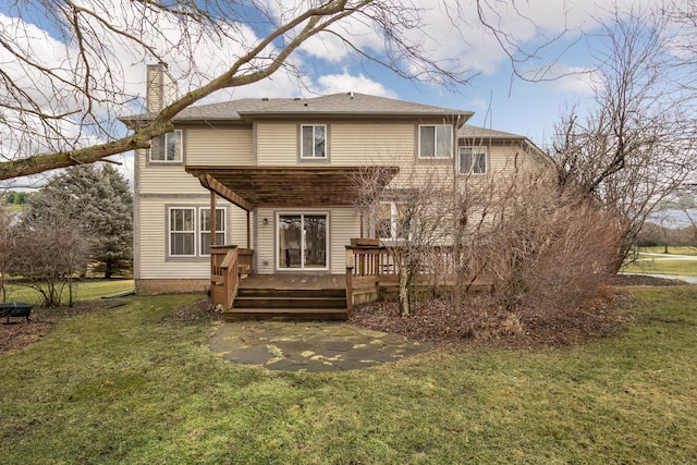 back of property with a chimney, a deck, and a yard