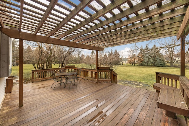 deck with outdoor dining area, a lawn, and a pergola