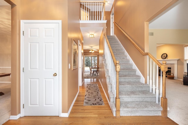 stairs with visible vents, baseboards, and wood finished floors