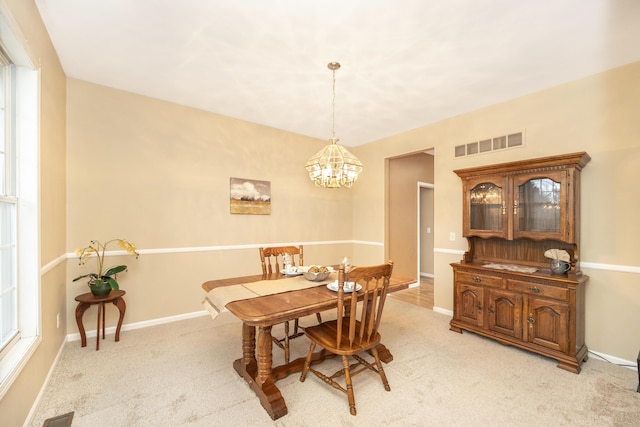 dining area with light carpet, baseboards, and visible vents