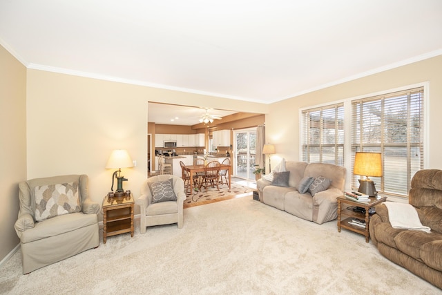 living area with ornamental molding, a healthy amount of sunlight, and light carpet