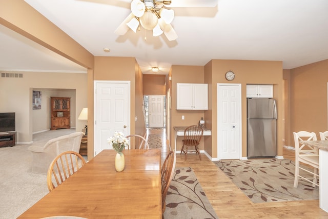 dining area featuring visible vents, ceiling fan, light wood-style flooring, and baseboards