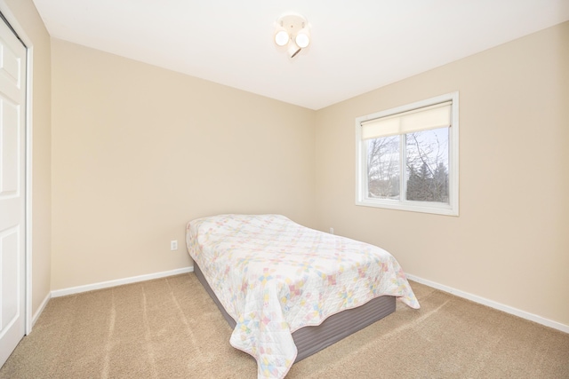 bedroom with carpet floors and baseboards