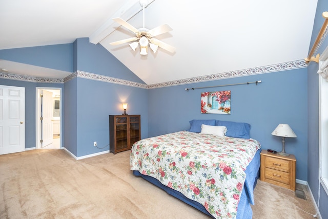 bedroom with lofted ceiling with beams, carpet flooring, a ceiling fan, baseboards, and ensuite bath