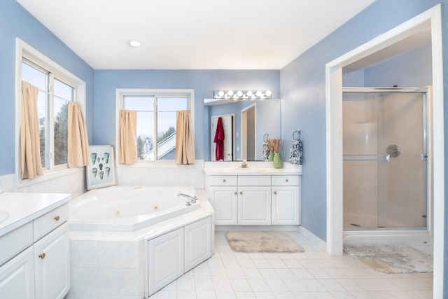 bathroom with a shower stall, a tub with jets, two vanities, and tile patterned floors