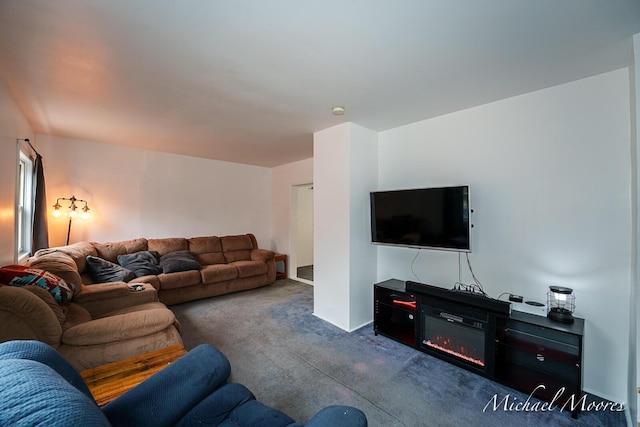 carpeted living room with a glass covered fireplace