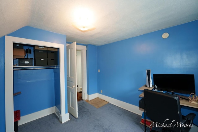 office area with carpet, vaulted ceiling, a textured ceiling, and baseboards