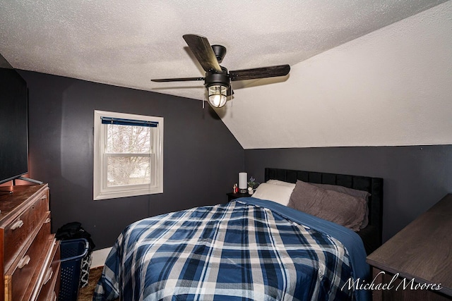 bedroom with vaulted ceiling, ceiling fan, and a textured ceiling