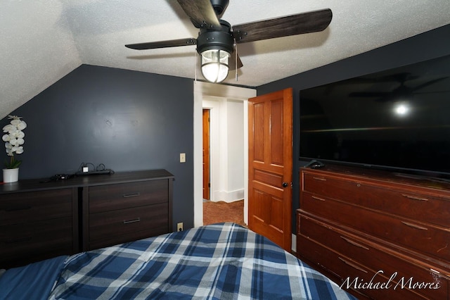 bedroom featuring lofted ceiling, ceiling fan, a textured ceiling, and carpet flooring