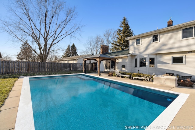 view of swimming pool with a patio area, a fenced backyard, a fenced in pool, and a gazebo