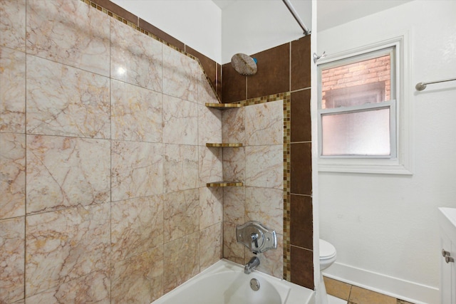 bathroom featuring washtub / shower combination, toilet, and baseboards