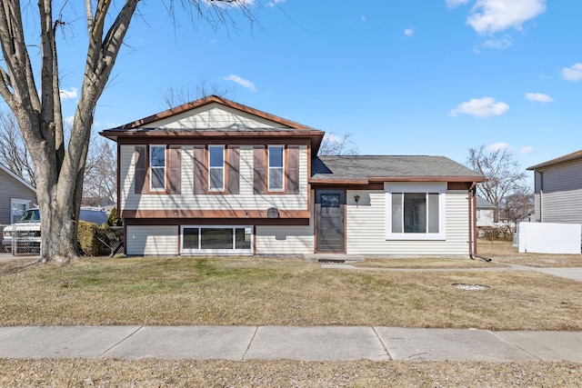 tri-level home with a front yard