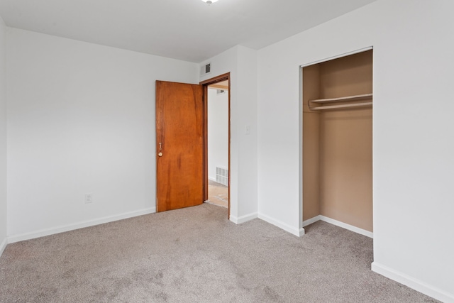 unfurnished bedroom featuring a closet, carpet flooring, visible vents, and baseboards