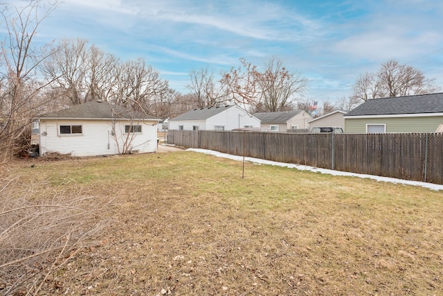 view of yard with a fenced backyard and a residential view