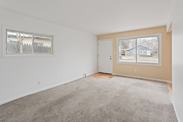 empty room with carpet and baseboards