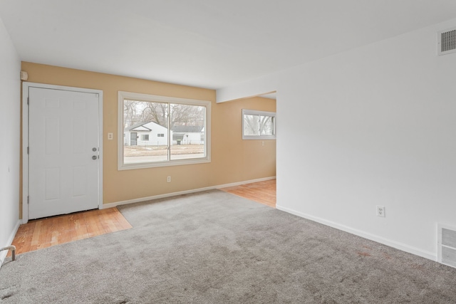 interior space featuring carpet, visible vents, and baseboards