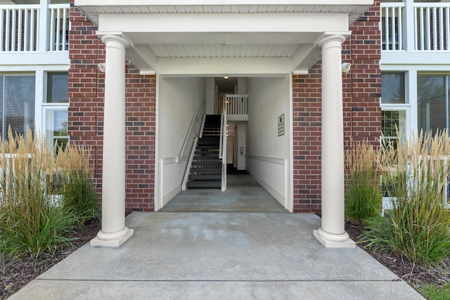 doorway to property featuring brick siding