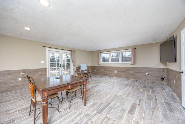 9915 85th Ave, Mecosta, MI 49332 - dining room with french doors, a textured ceiling, wainscoting, and wood finished floors