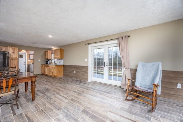 9915 85th Ave, Mecosta, MI 49332 - kitchen featuring french doors, wainscoting, refrigerator, wood finished floors, and a sink