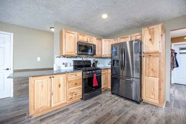 9915 85th Ave, Mecosta, MI 49332 - kitchen featuring black refrigerator with ice dispenser, wood finished floors, light brown cabinetry, stainless steel microwave, and range with gas cooktop