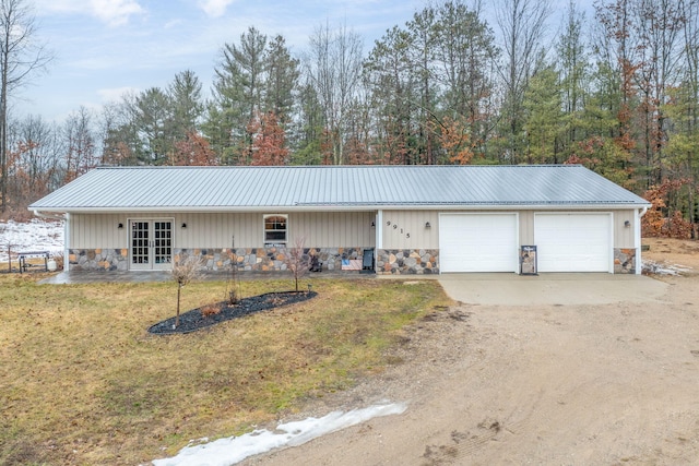 9915 85th Ave, Mecosta, MI 49332 - ranch-style house with french doors, a front yard, metal roof, and stone siding