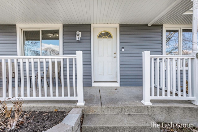 view of exterior entry featuring a porch