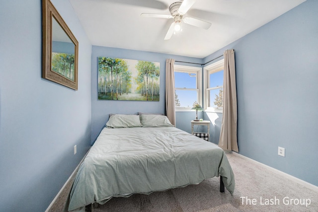 carpeted bedroom with a ceiling fan and baseboards