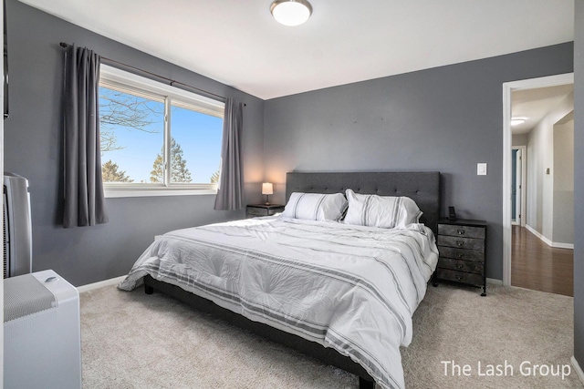 bedroom with carpet floors and baseboards