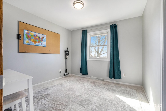 empty room with carpet floors, visible vents, and baseboards