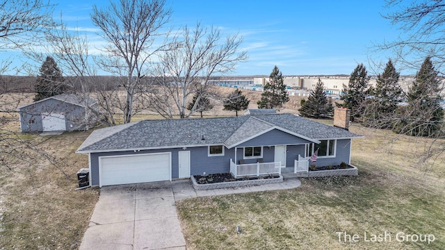 single story home featuring a garage, concrete driveway, a chimney, covered porch, and a front lawn