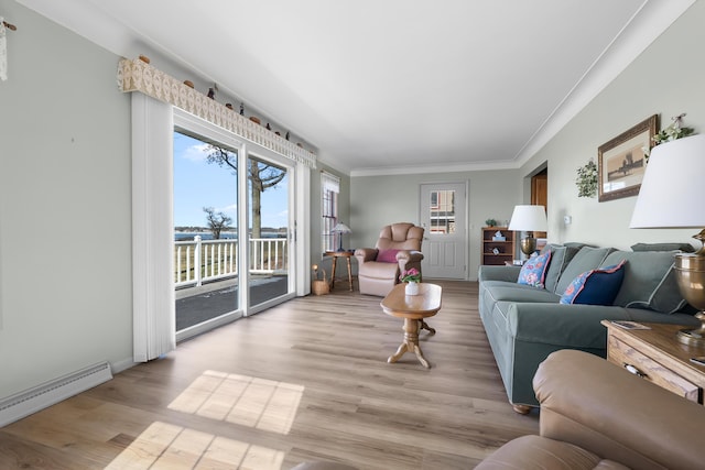 living room featuring a baseboard heating unit, ornamental molding, and wood finished floors