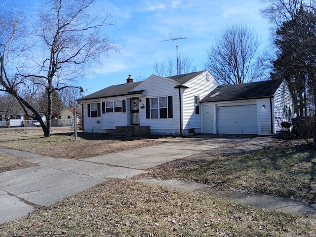 view of front of property featuring an attached garage, concrete driveway, a chimney, and fence