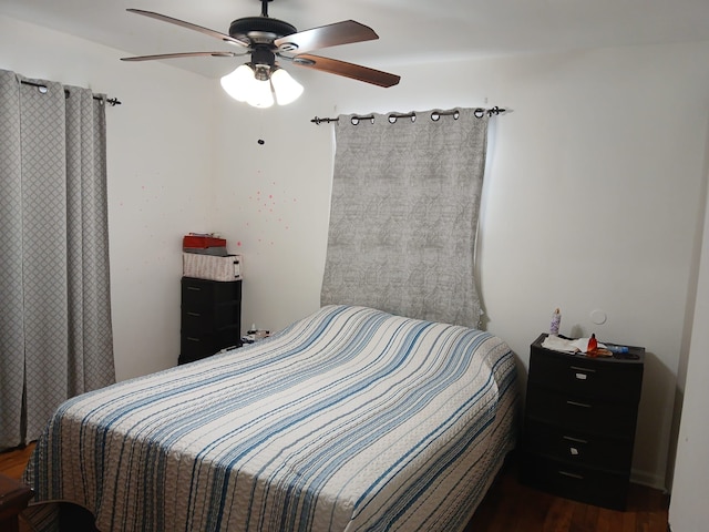 bedroom featuring a ceiling fan and dark wood-style flooring