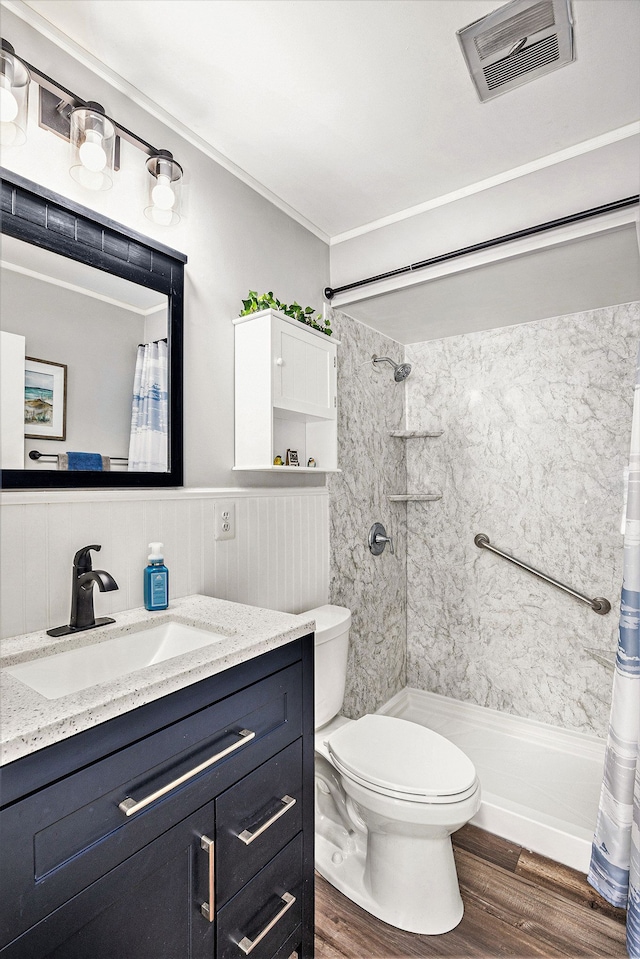 bathroom with visible vents, toilet, wood finished floors, a shower with shower curtain, and vanity