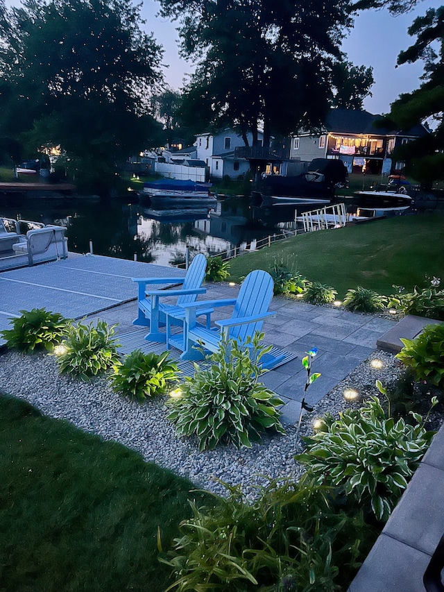 view of home's community featuring a lawn and a patio area