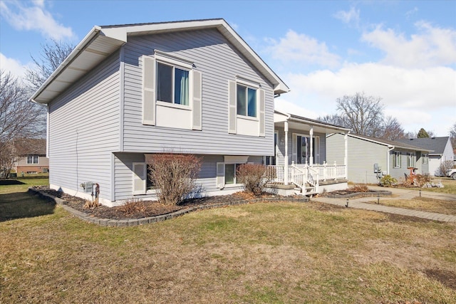 view of front of home with covered porch and a front lawn