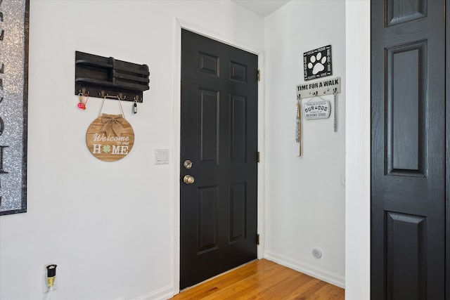 foyer entrance with light wood-type flooring and baseboards