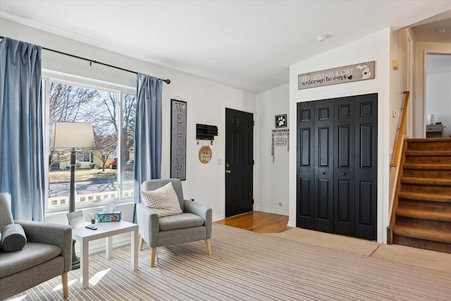 living area with vaulted ceiling and stairs