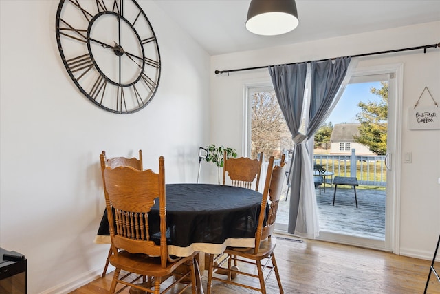 dining room featuring baseboards and wood finished floors