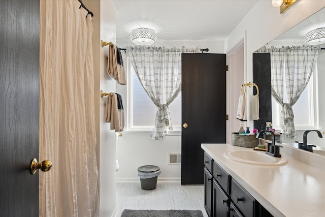 full bathroom featuring vanity, visible vents, and baseboards