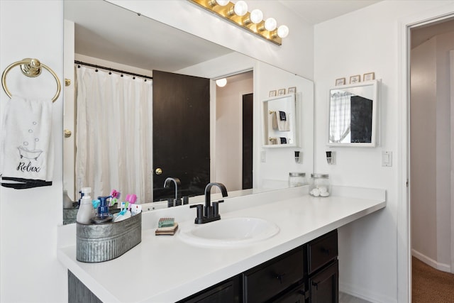 full bathroom featuring baseboards and vanity