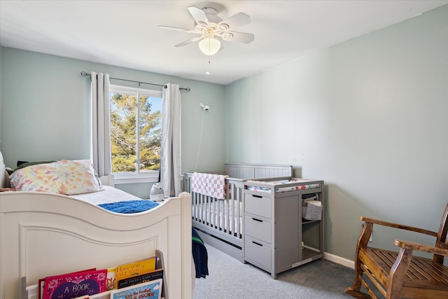 carpeted bedroom with a ceiling fan and baseboards