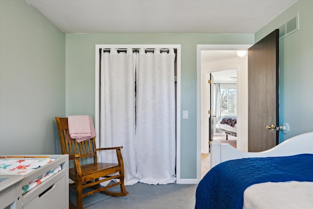 bedroom with light colored carpet, visible vents, and baseboards