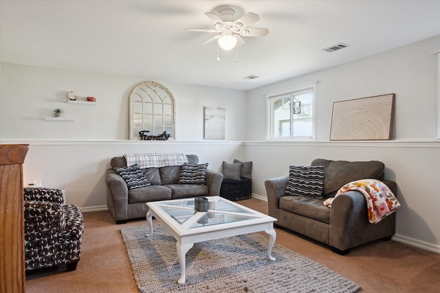 carpeted living room with ceiling fan, visible vents, and baseboards