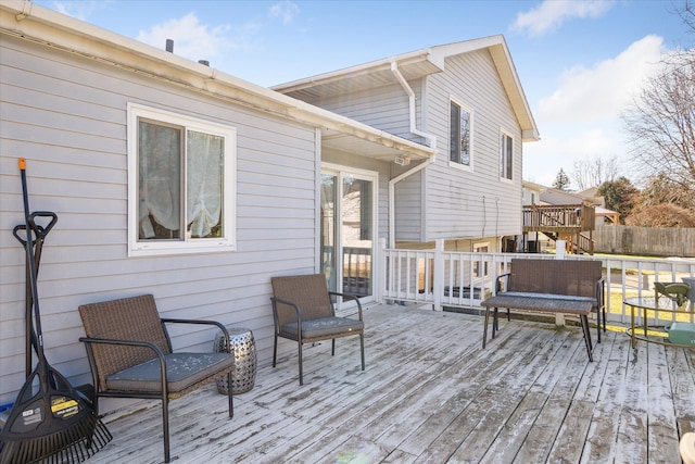 wooden terrace featuring fence