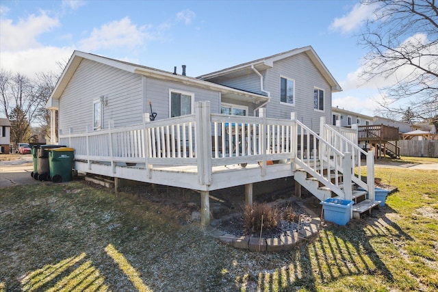 rear view of house featuring a wooden deck and stairs