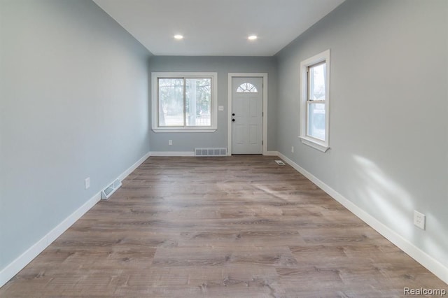 entrance foyer featuring visible vents, plenty of natural light, and baseboards